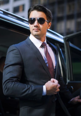 Chauffeur standing with a limo